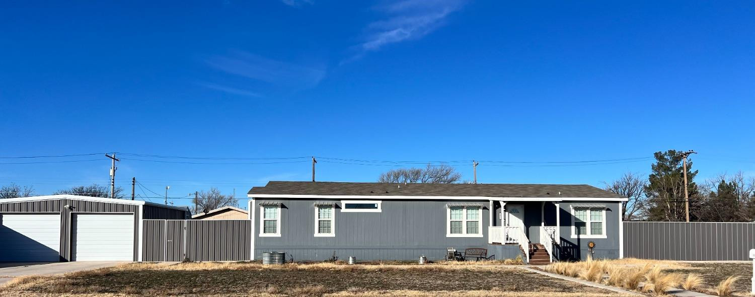 1021 Avenue North Ralls, TX 79357 - Photo 2 of 29 a front view of a house with a yard
