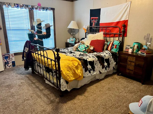 a bedroom with bed and a window