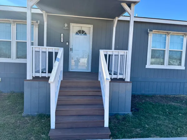 a view of a house with wooden floor and a porch