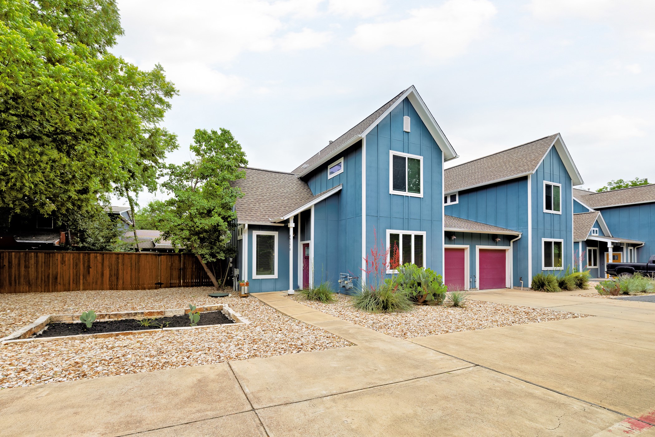4917 Sunset Trail, Unit A Austin, TX 78745 - Photo 1 of 36 View of front of property with board and batten siding, a shingled roof, concrete driveway, and a garden
