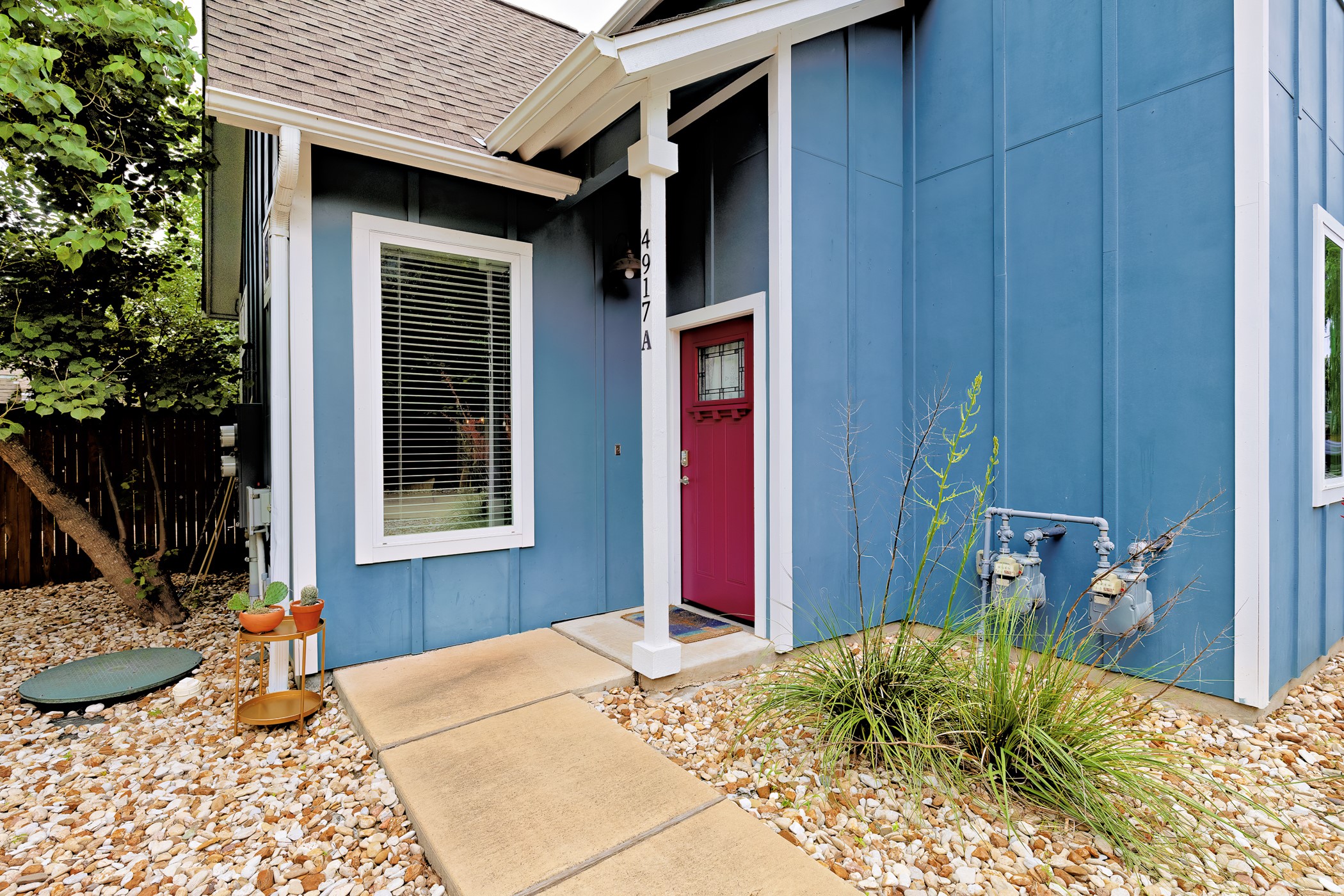 4917 Sunset Trail, Unit A Austin, TX 78745 - Photo 32 of 36 Doorway to property with board and batten siding and a shingled roof