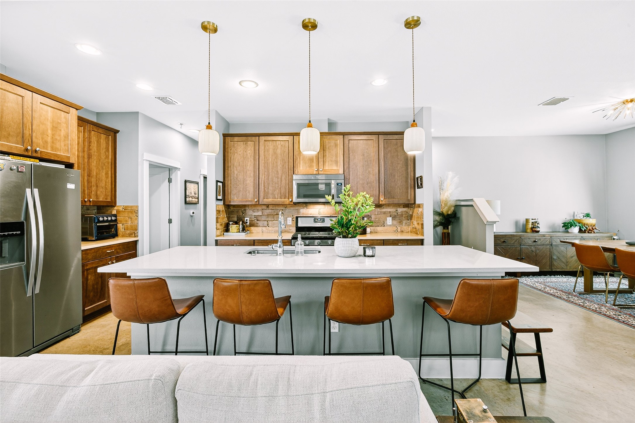 4917 Sunset Trail, Unit A Austin, TX 78745 - Photo 33 of 36 Kitchen with stainless steel appliances, a kitchen breakfast bar, open floor plan, a kitchen island with sink, and wood finish cabinetry