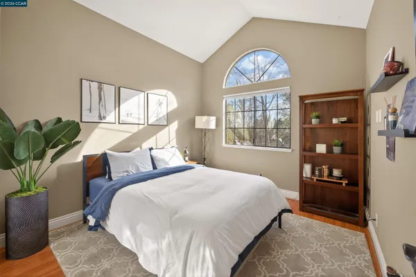 a bedroom with a bed and a window