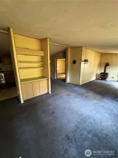 a view of a room with a furniture and a window