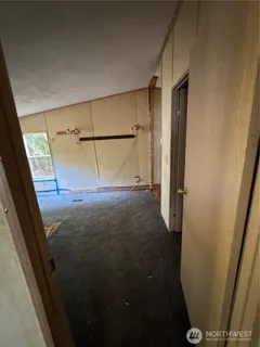a view of a room with wooden floor and windows