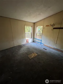 a view of a room with wooden floor