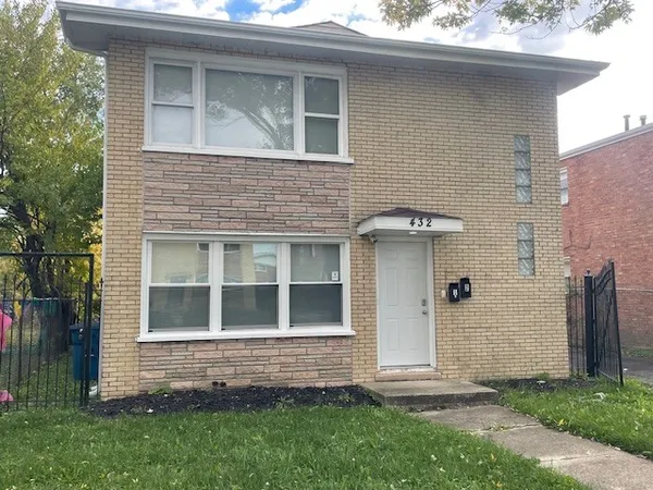 a brick house with a small yard