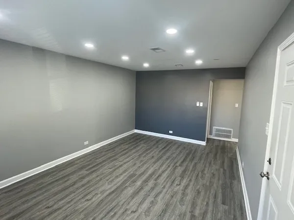 a view of room with wooden floor and window