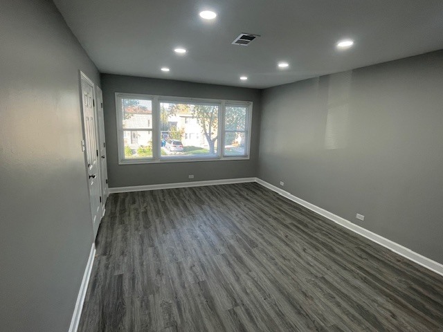 432 West Hickory Street, Unit 1 Chicago Heights, IL 60411 - Photo 5 of 11 an empty room with wooden floor and windows