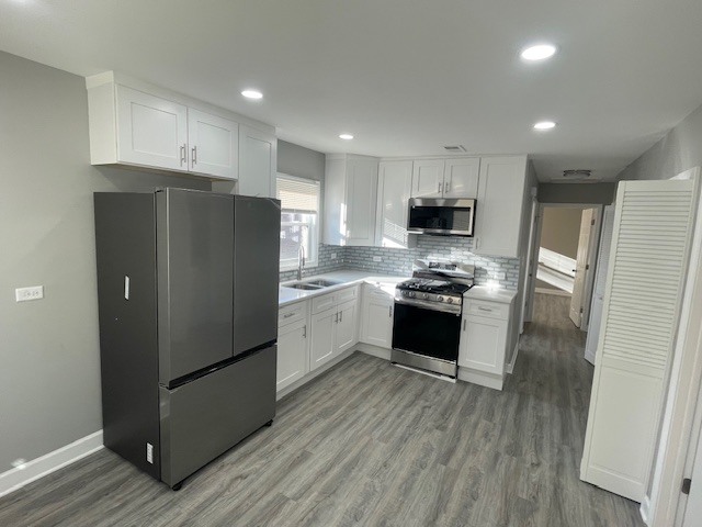 432 West Hickory Street, Unit 1 Chicago Heights, IL 60411 - Photo 7 of 11 a kitchen with granite countertop white cabinets and stainless steel appliances
