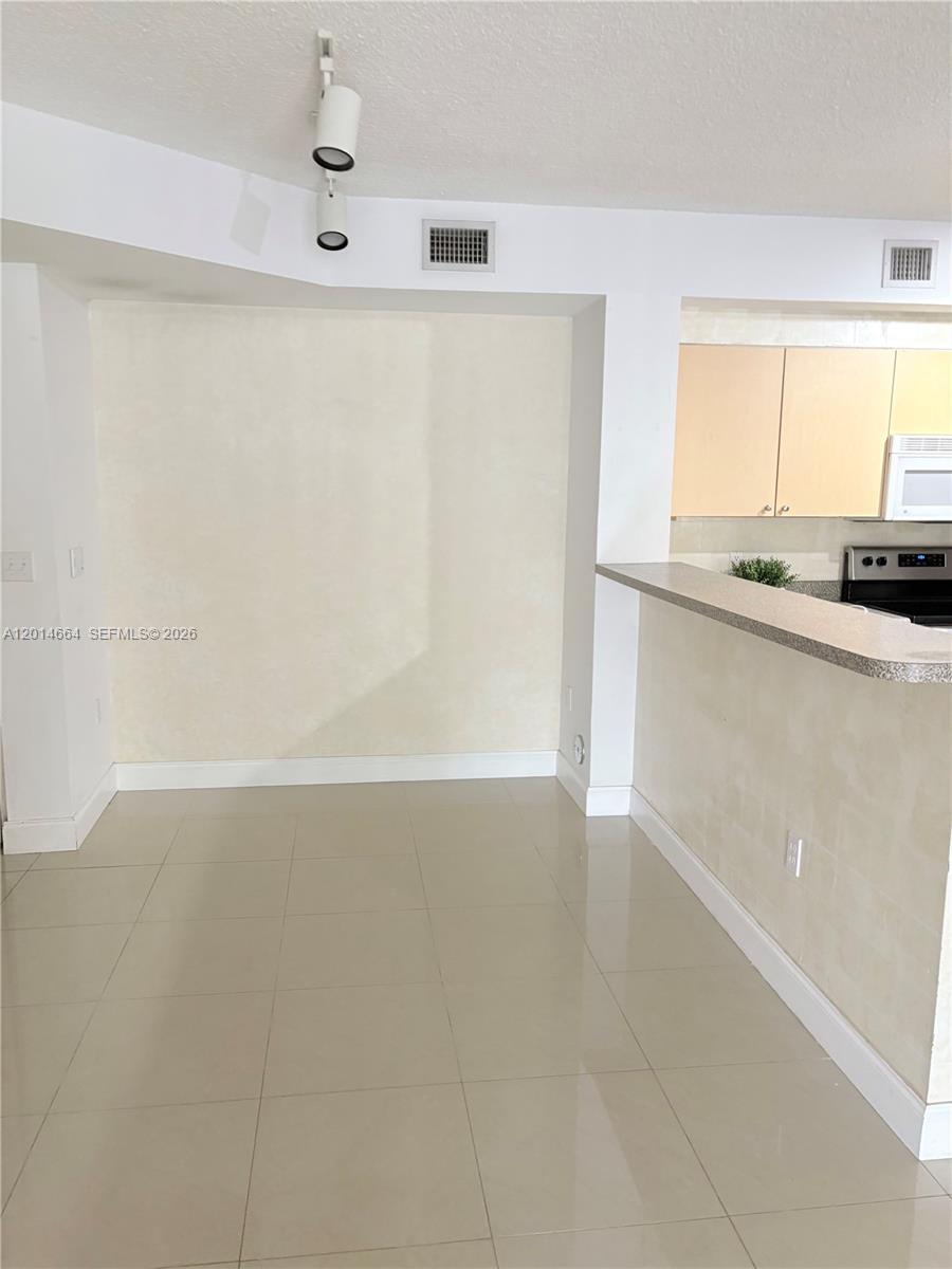 8030 North Nob Hill Road, Unit 105 Tamarac, FL 33321 - Photo 3 of 22 a view of kitchen with stainless steel appliances cabinets and a window