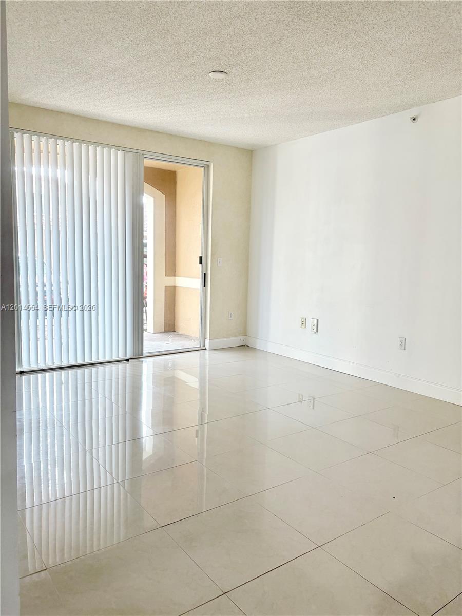 8030 North Nob Hill Road, Unit 105 Tamarac, FL 33321 - Photo 4 of 22 a view of an empty room with a window
