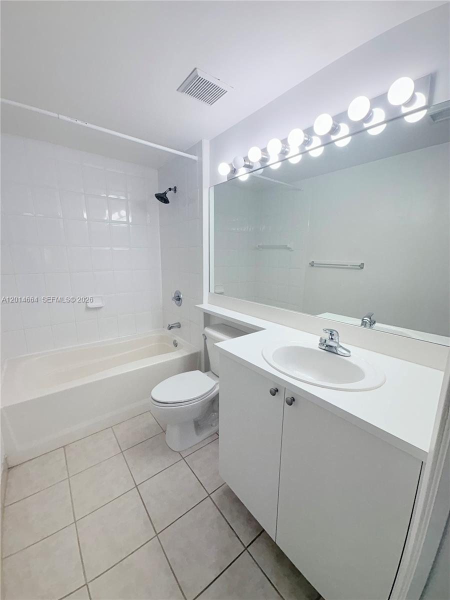 8030 North Nob Hill Road, Unit 105 Tamarac, FL 33321 - Photo 10 of 22 a bathroom with a sink a toilet and shower