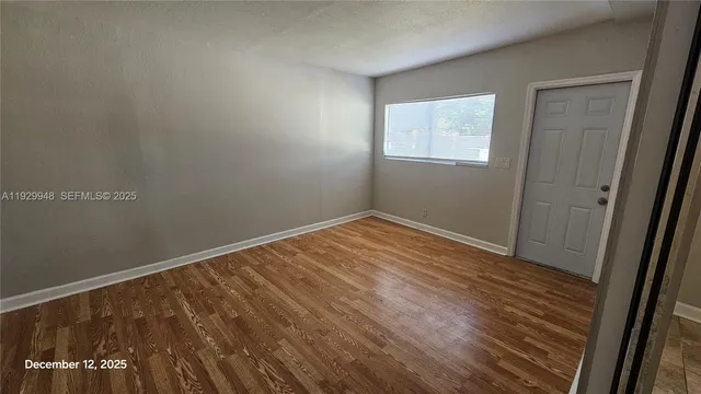 a bathroom with a granite countertop sink a mirror and bathtub