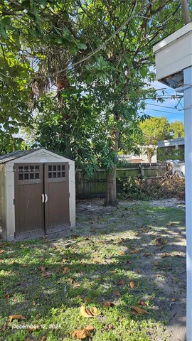 a backyard of a house with table and chairs