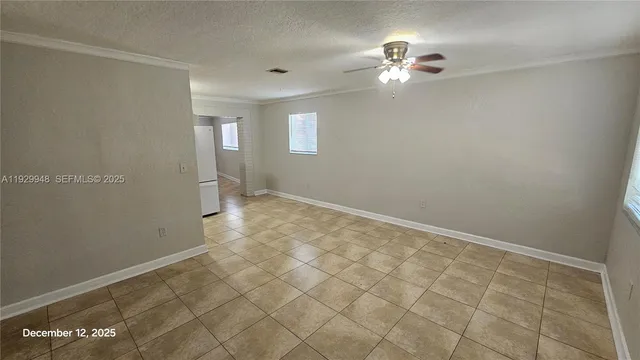 a view of a kitchen with a sink and a refrigerator
