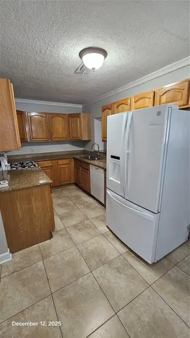 a view of an empty room with a chandelier fan