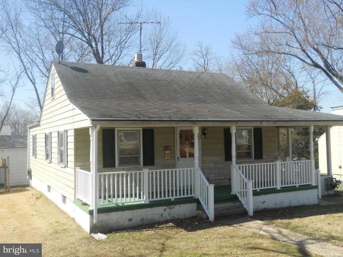 11700 Idlewood Road Silver Spring, MD 20906 - Photo 14 of 17 a view of a house with a small yard and wooden fence
