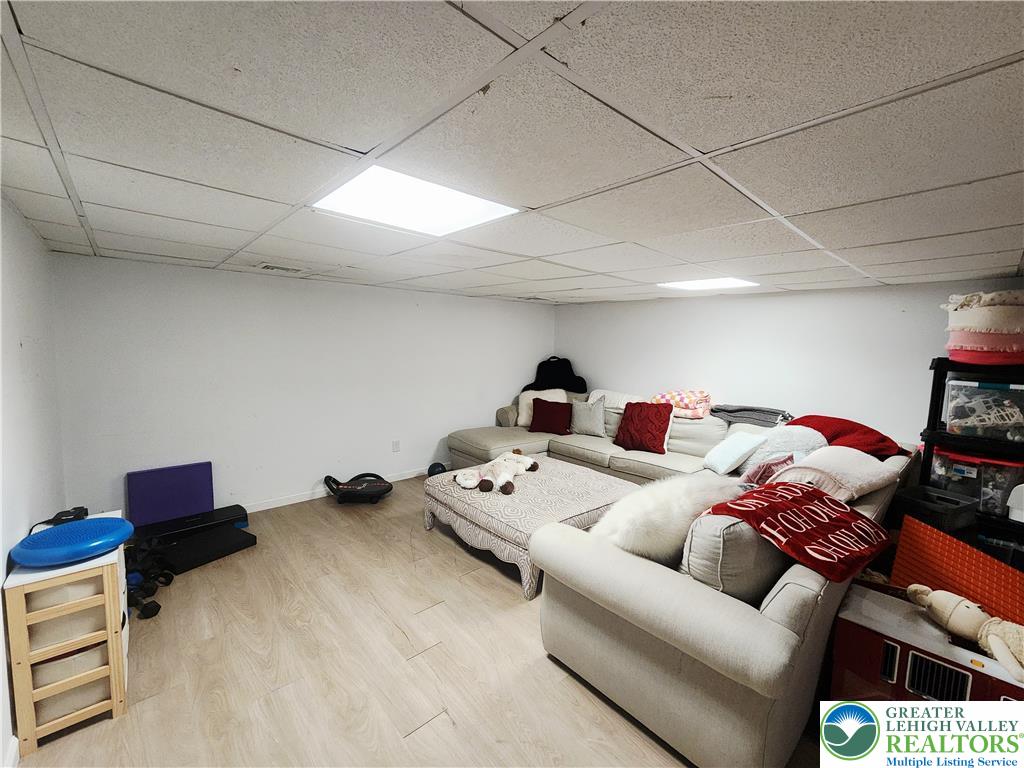 237 Ridings Circle Macungie, PA 18062 - Photo 68 of 70 A fully finished basement features resilient wood-look flooring and integrated overhead panel lighting.