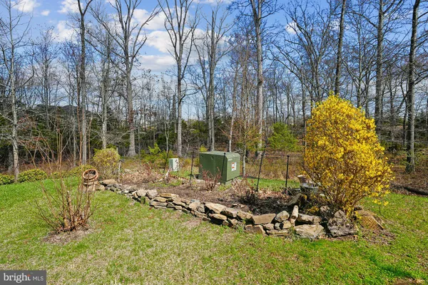 a view of staircase with railing and a rug