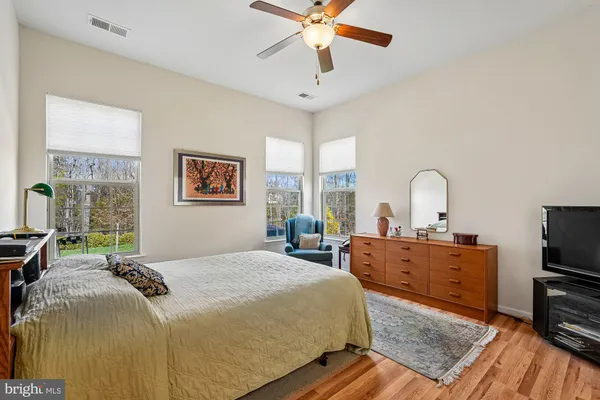 a spacious bathroom with a granite countertop sink mirror and toilet