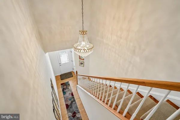 a view of livingroom with a potted plant a ceiling fan and a window