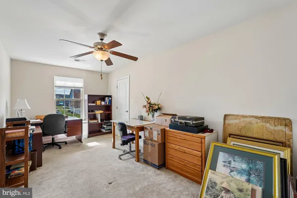 a living room with furniture a rug and white walls