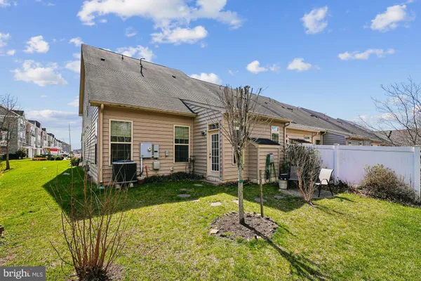 a view of a house with a big yard and potted plants