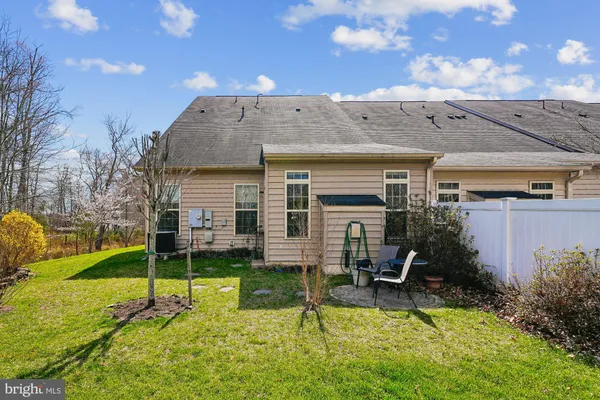 a view of a house with backyard porch and sitting area