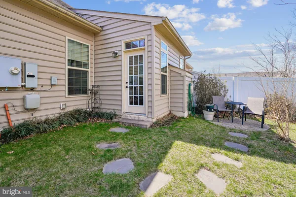 a view of backyard with a garden and chairs