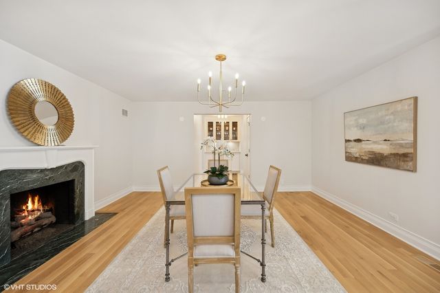 a dining room with furniture and a fireplace