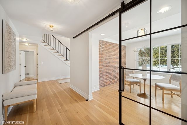 a view of entryway with wooden floor and door