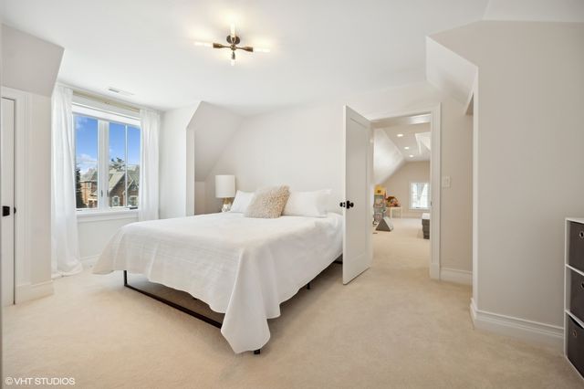 a bedroom with a bed and a painting