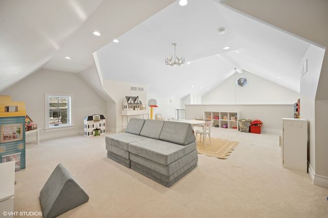 a living room with furniture and kitchen view