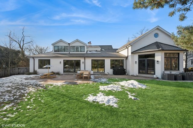a view of a garden with lawn chairs