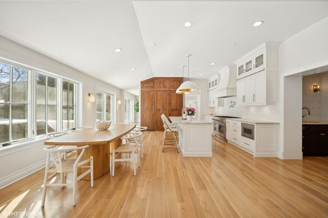 a large kitchen with a table and chairs