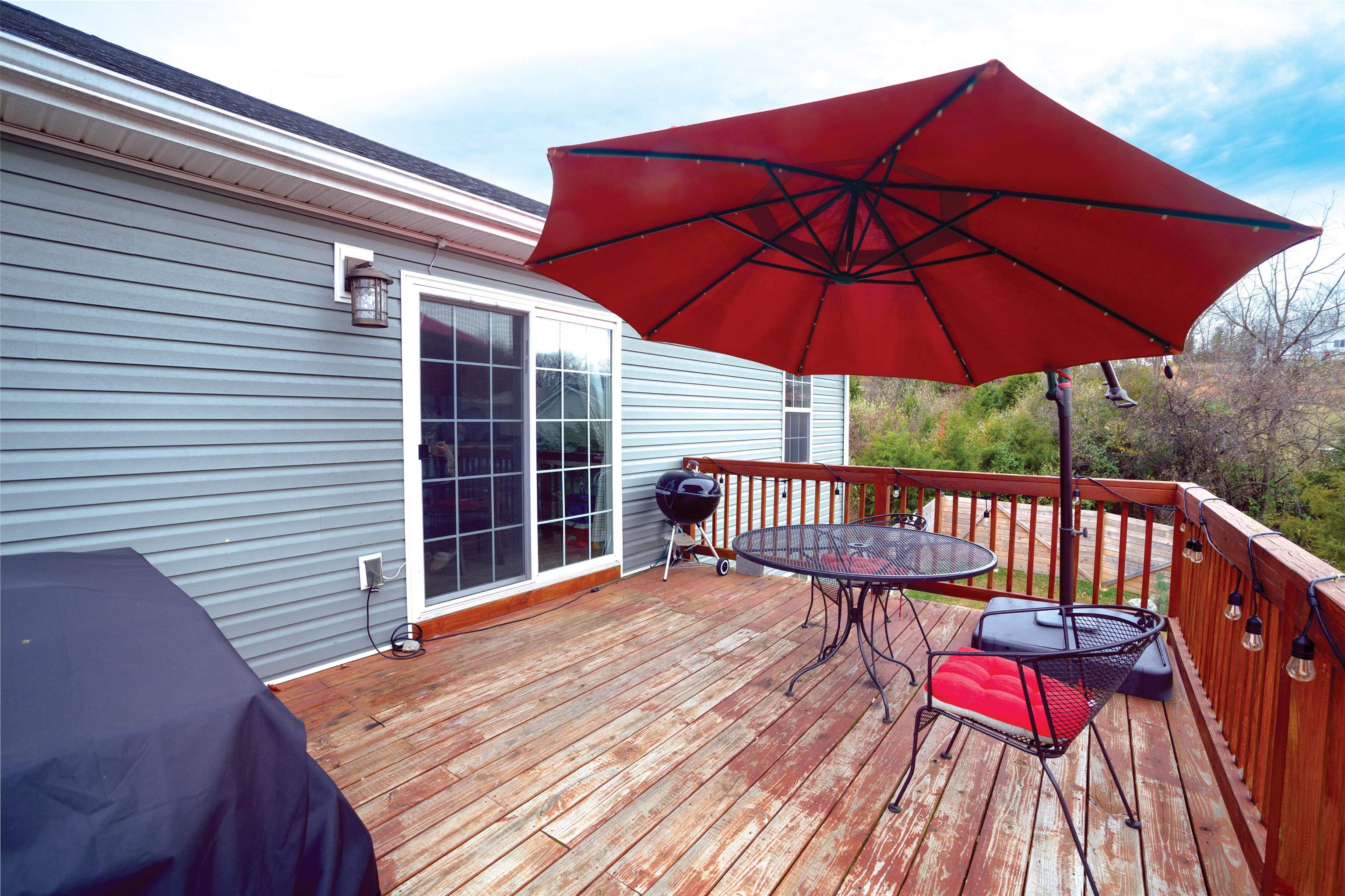 1771 Marble Ridge Drive Harrisonburg, VA 22801 - Photo 35 of 49 a view of a roof deck with a table and chairs under an umbrella