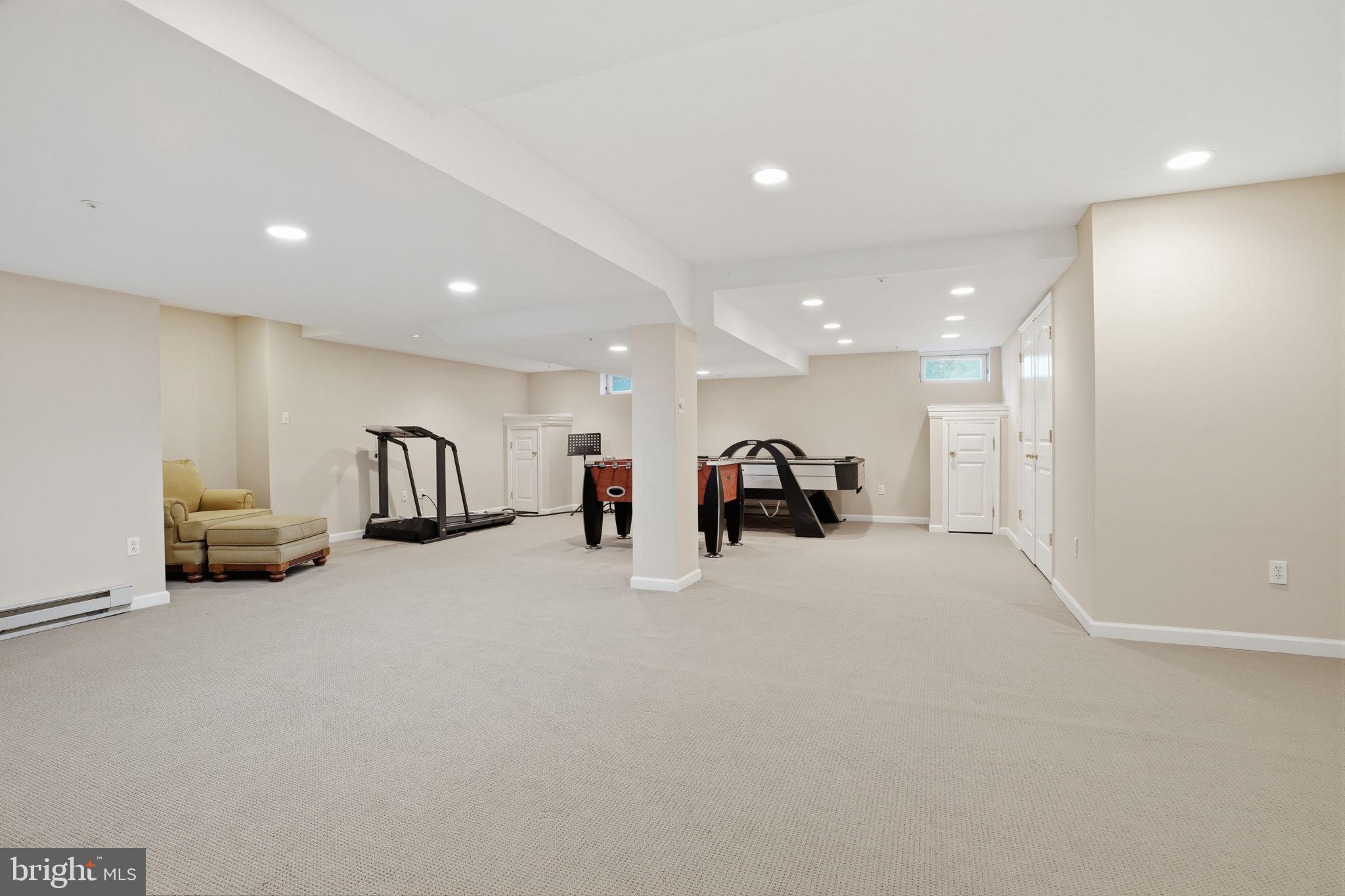 53 Alexanders Court Newtown, PA 18940 - Photo 42 of 61 a view of a room with gym equipment and a chandelier