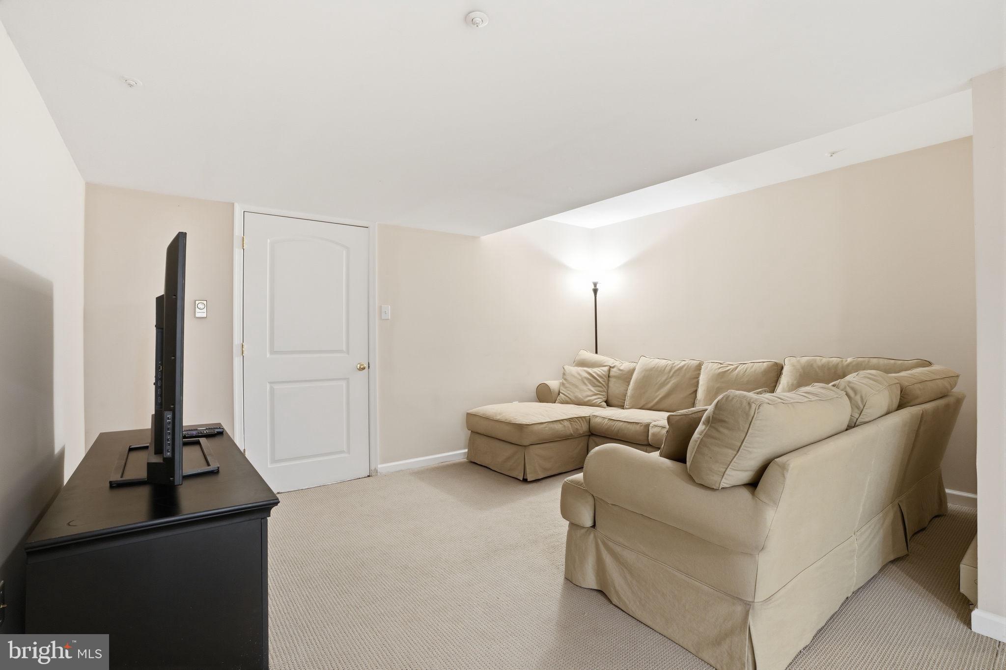 53 Alexanders Court Newtown, PA 18940 - Photo 45 of 61 a living room with furniture and a flat screen tv