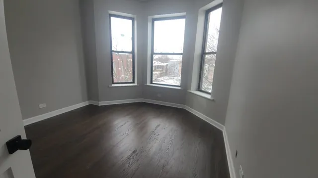 an empty room with wooden floor