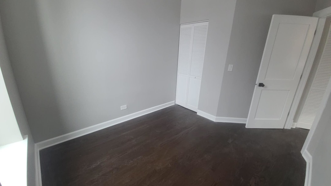 6443 South Peoria Street, Unit 1 Chicago, IL 60621 - Photo 12 of 13 an empty room with wooden floor