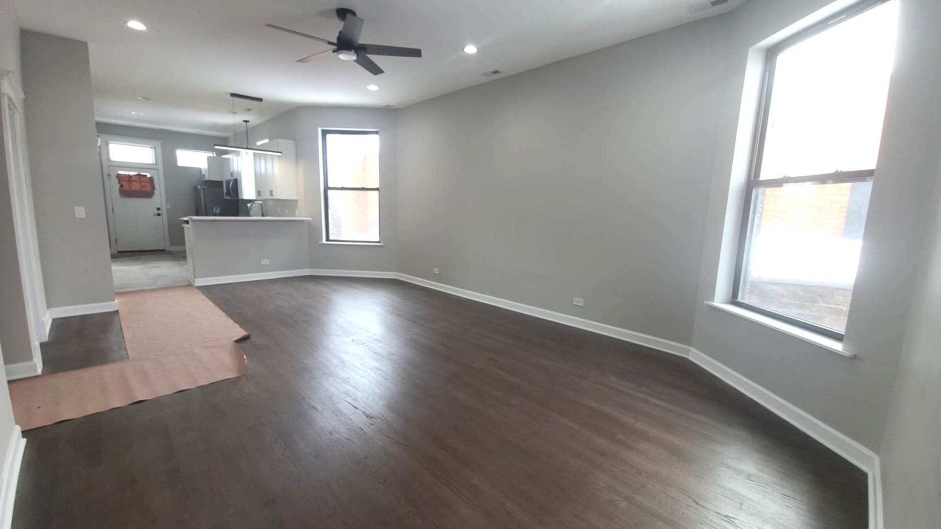 6443 South Peoria Street, Unit 1 Chicago, IL 60621 - Photo 3 of 13 an empty room with wooden floor and windows