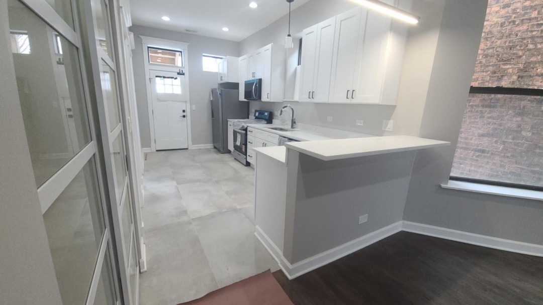 6443 South Peoria Street, Unit 1 Chicago, IL 60621 - Photo 4 of 13 a bathroom with a sink and mirror