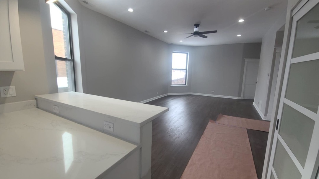6443 South Peoria Street, Unit 1 Chicago, IL 60621 - Photo 5 of 13 a view of hallway with window and wooden floor