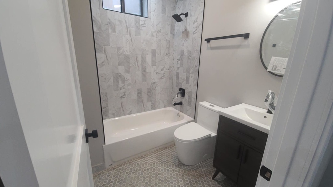 6443 South Peoria Street, Unit 1 Chicago, IL 60621 - Photo 6 of 13 a bathroom with a toilet sink and bathtub