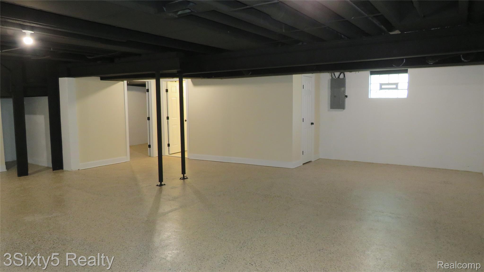 16558 Haggerty Road Belleville, MI 48111 - Photo 30 of 40 Spacious lower level featuring light-colored flooring, painted walls, and an exposed black ceiling