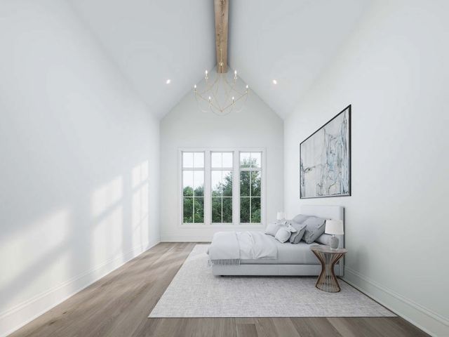 a spacious bedroom with a bed and a couch