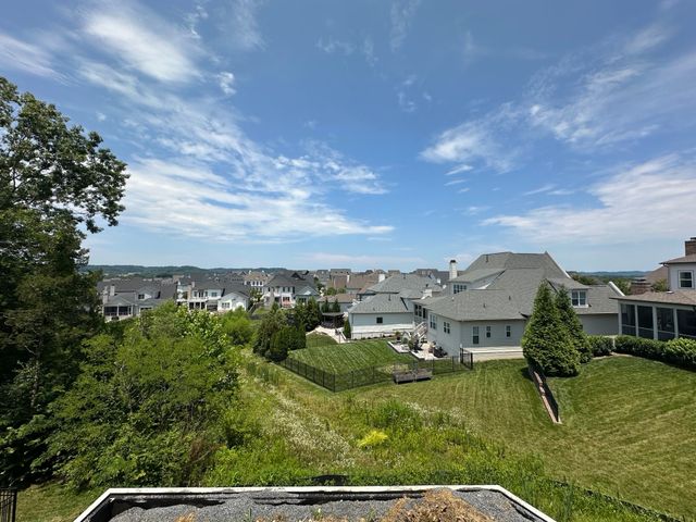 a view of residential houses with outdoor space and street view