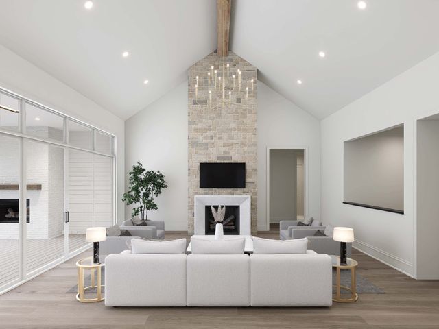 a living room with furniture a fireplace and a chandelier