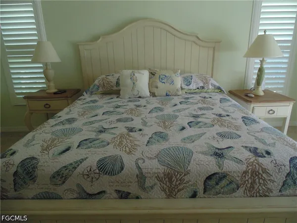 a bedroom with a bed and a lamp